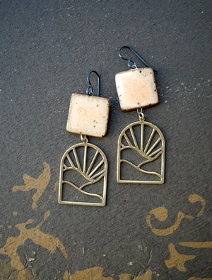 a pair of earrings sitting on top of a floor