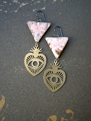 a pair of earrings with a triangle and a heart