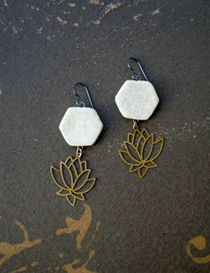 a pair of earrings sitting on top of a floor