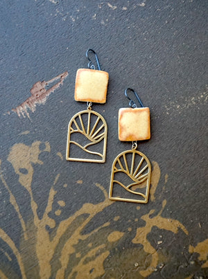 a pair of earrings sitting on top of a table