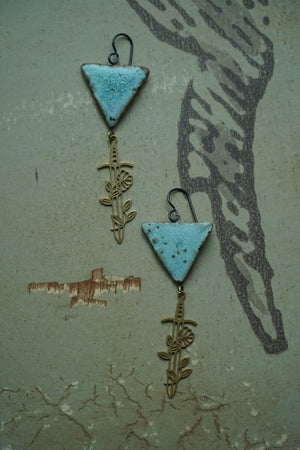 a pair of earrings that are on a table