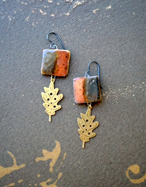 a pair of earrings sitting on top of a table