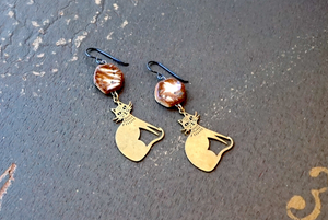 a pair of earrings sitting on top of a table
