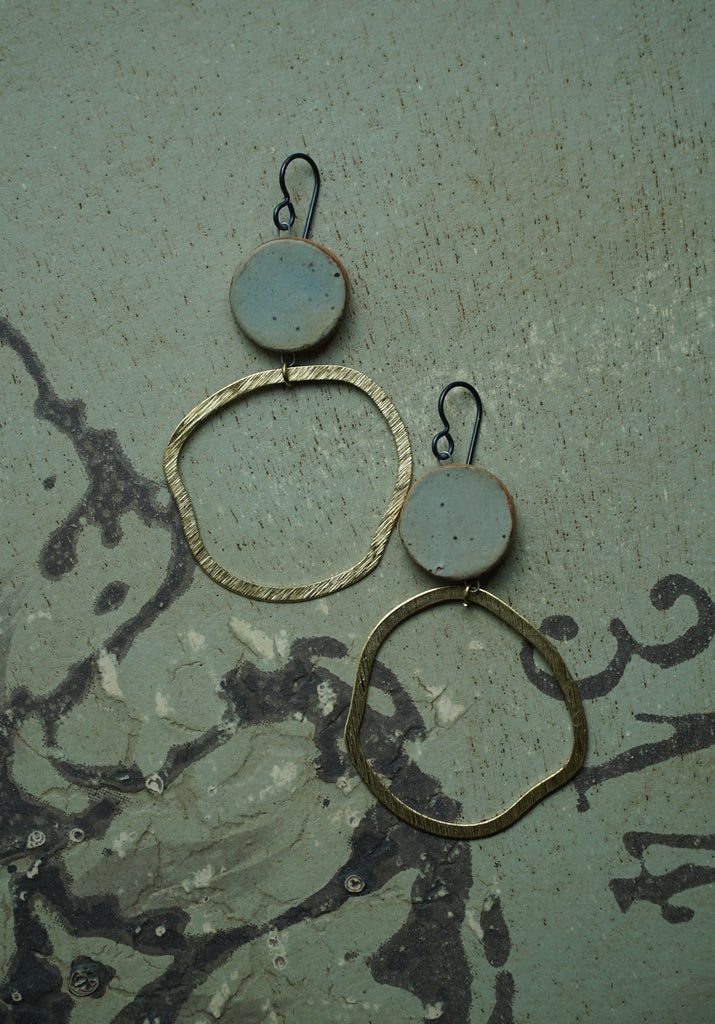 a pair of earrings sitting on top of a table