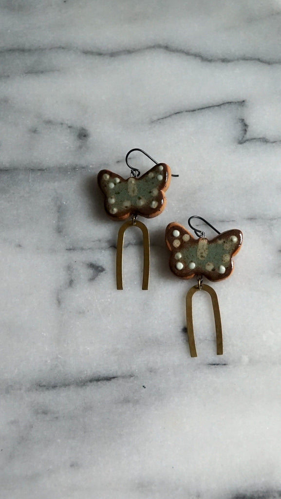 glazed stoneware clay earrings with hypoallergenic ear wires, made in Asheville, NC , statement earrings, art earrings , lightweight earrings , handmade jewelry , niobium , sensitive ears , one of a kind earrings , handmade , brass cat charm